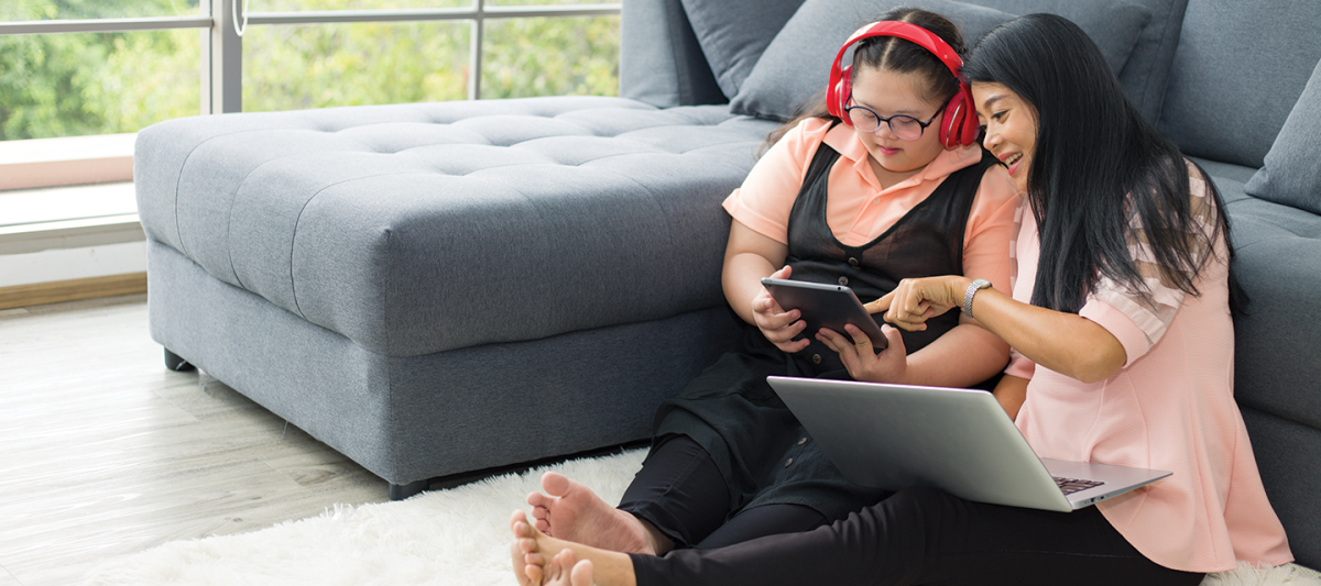 two people lounging on a living room floor