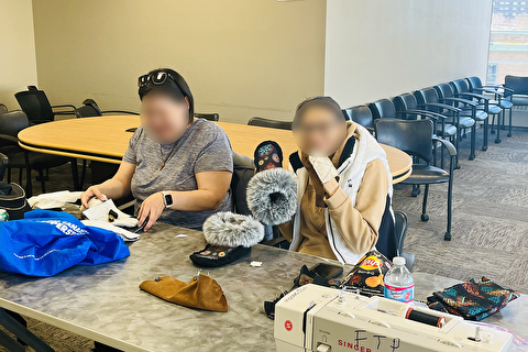 Parents sewing moccasins
