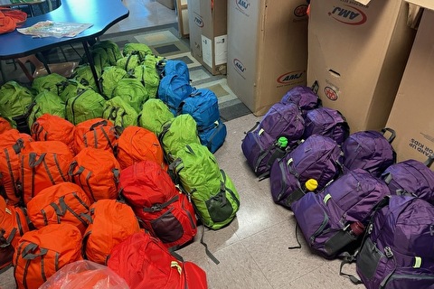 rows of colourful backpacks